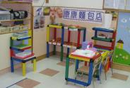 This photo shows the play corner with the theme `Food’.  Here is a `bakery’.  Children play the roles of baker, cashier and customer.