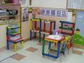 This photo shows the play corner with the theme `Food’.  Here is a `bakery’.  Children play the roles of baker, cashier and customer.